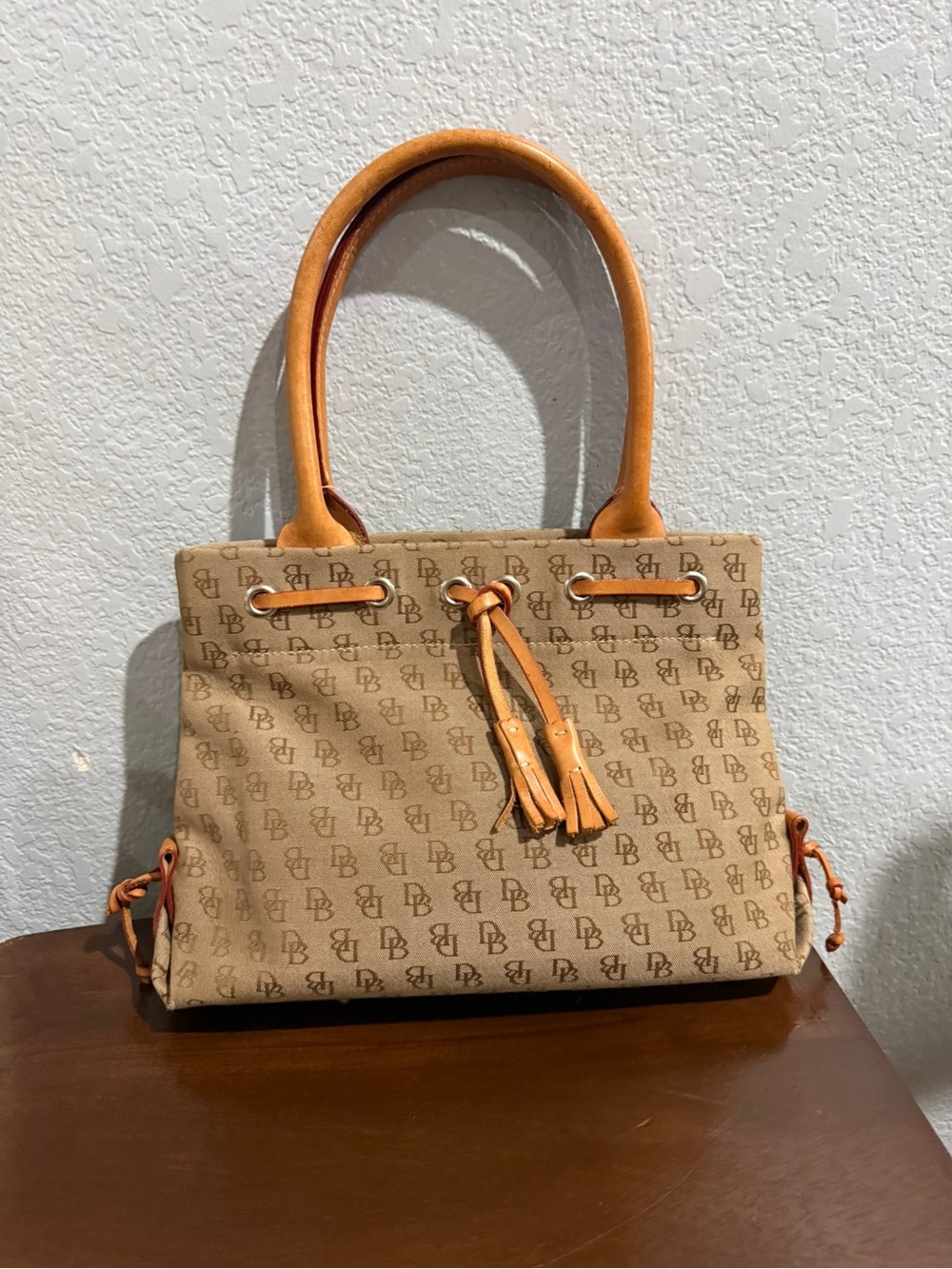 Dooney & Burke Signature Canvas Mini Tassel Tan Tote.